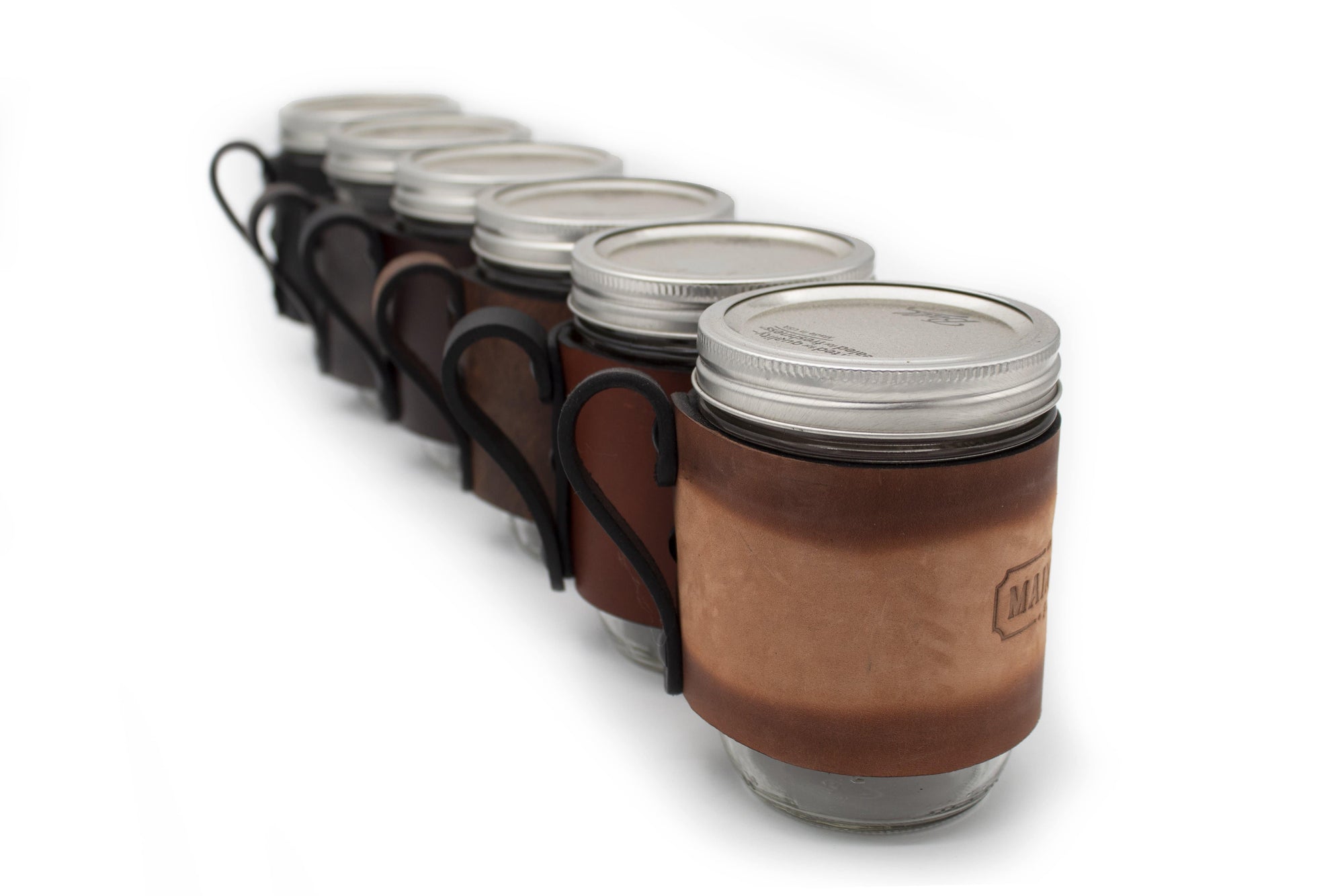 https://mainstreetforge.com/cdn/shop/products/mason-jar-wrap-with-handle-for-hot-cold-drinks-made-in-usa-with-lifetime-warranty-main-street-forge-small-goods-19672094146719_2000x.jpg?v=1602680977